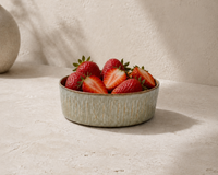 Sage Taupe stoneware bowl with fresh strawberries on a light stone surface