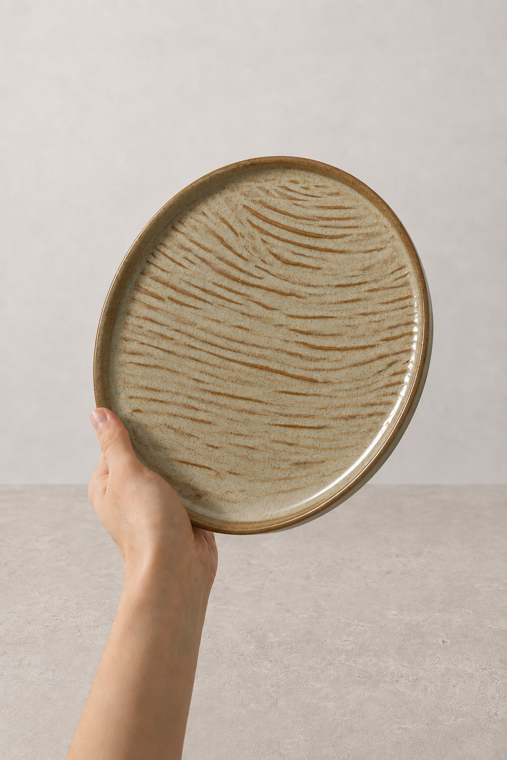 Sage Taupe textured stoneware ceramic plate held in hand